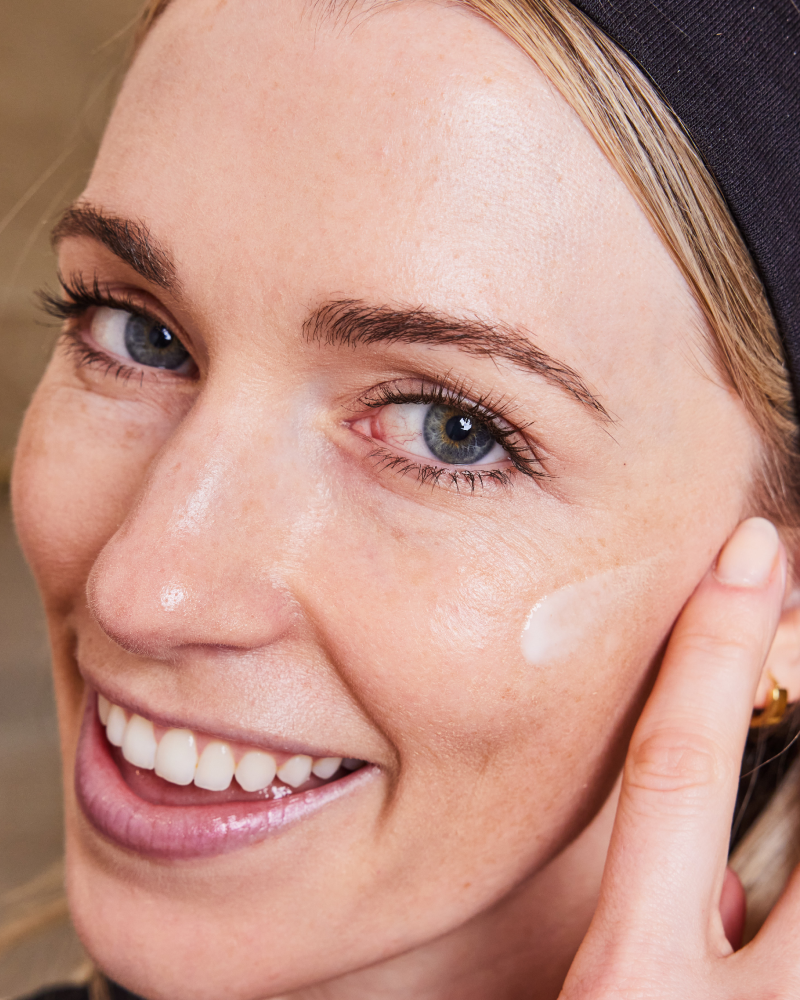 Close-up of woman applying NMF Hydrator Barrier Repair by Dr. Stefani Kappel for hydration and Healthy Skin From Within