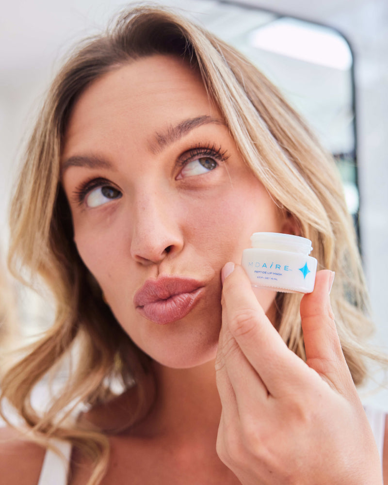 Rush Hour Duo with woman holding open jar of eye cream near cheek in gallery position 1 close-up shot